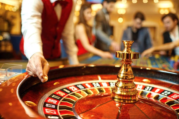 Mobile phone screen showing emon 77 AduQ table with betting controls and live dealer feed